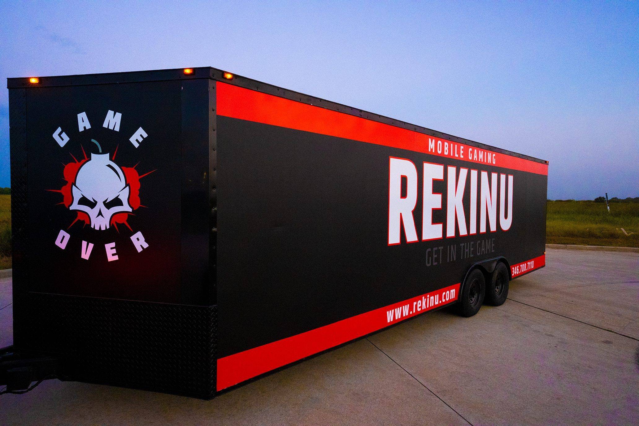 Rekinu's actual black and red mobile gaming trailer with large white side lettering
